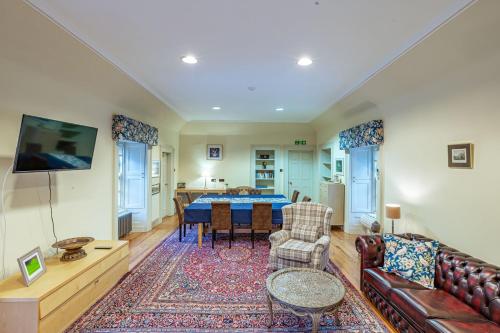 a living room with a couch and a table at Penninghame Estate - Stewart Apartment in Challoch