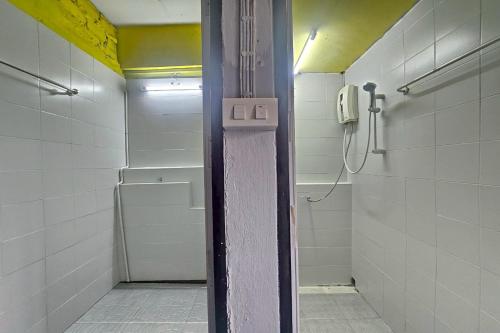 a bathroom with a shower and a phone on the wall at Me U Hostel in Chiang Mai