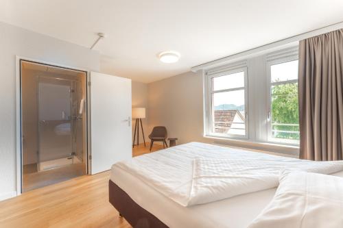 a bedroom with a large bed and a window at Gasthof Mühle in Aesch