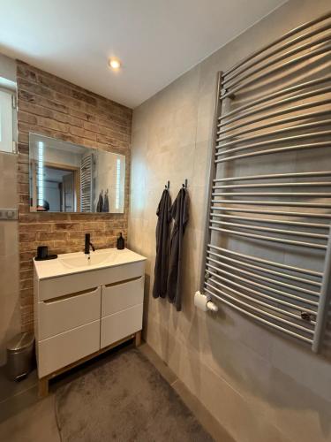 a bathroom with a sink and a mirror at Dom pod hradom s kinom a saunou 