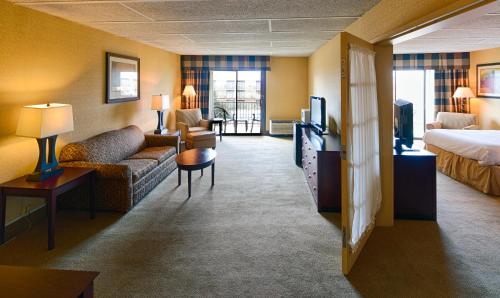 a hotel room with a couch and a bed at Red Lion Hotel Harrisburg Hershey in Harrisburg