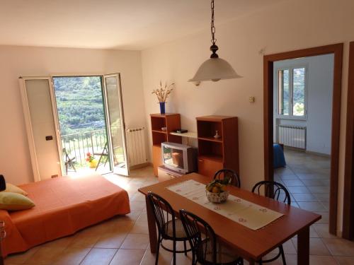 a living room with a bed and a dining table at Agriturismo Turlin in Vallebona