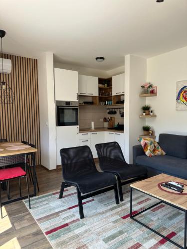 a living room with a couch and chairs and a table at Apartman PLAY Divčibare - 2 spavaće sobe in Divčibare