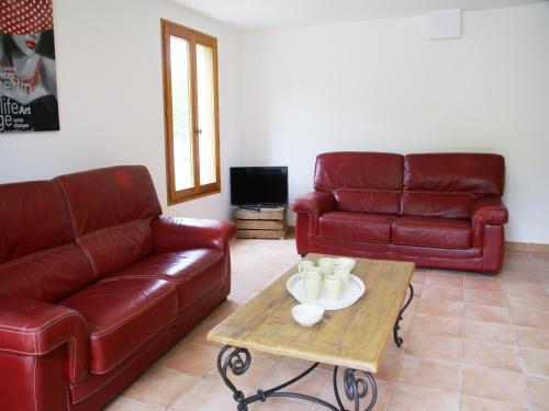 a living room with two leather couches and a coffee table at Captivating Holiday Home in Les Vans with Pool in Les Vans