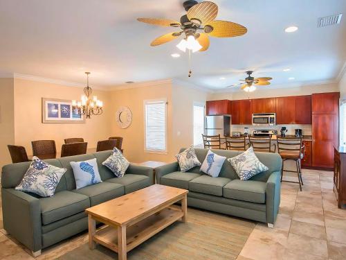 a living room with two couches and a kitchen at Hawks Cay Resort in Marathon