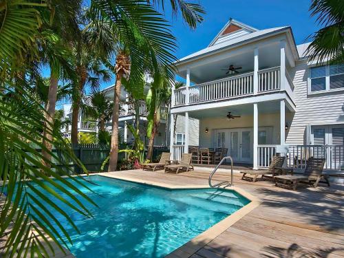 a house with a swimming pool in front of a house at Hawks Cay Resort in Marathon