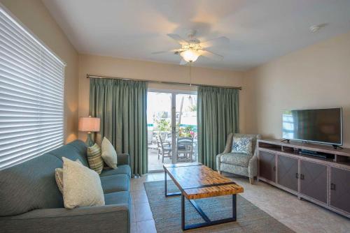 a living room with a couch and a tv and a table at Hawks Cay Resort in Marathon