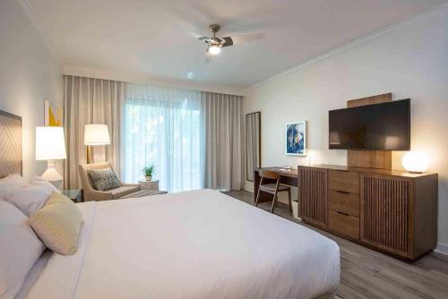 a hotel room with a large bed and a desk at Hawks Cay Resort in Marathon