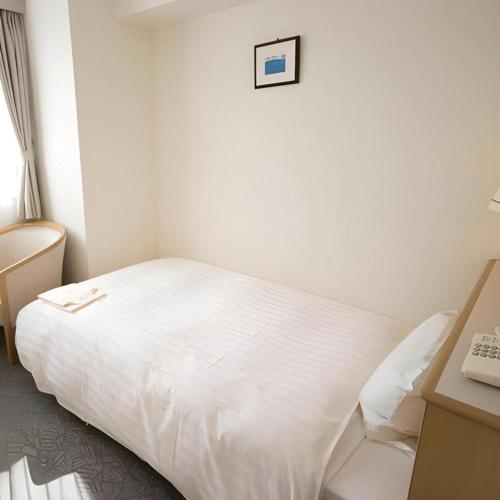 Кровать или кровати в номере Hotel Park Inn Toyama
