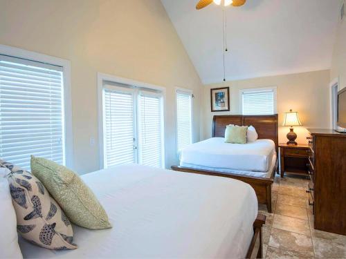 a bedroom with two beds and two windows at Hawks Cay Resort in Marathon