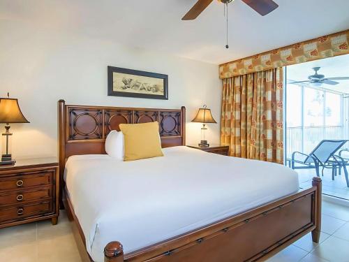 a bedroom with a large bed and a balcony at Hawks Cay Resort in Marathon