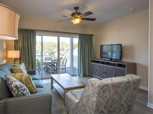a living room with a couch and a tv at Hawks Cay Resort in Marathon