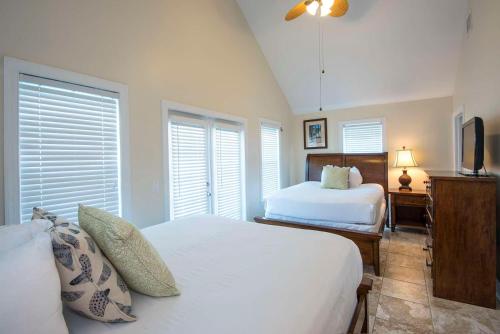 a bedroom with two beds and a tv in it at Hawks Cay Resort in Marathon