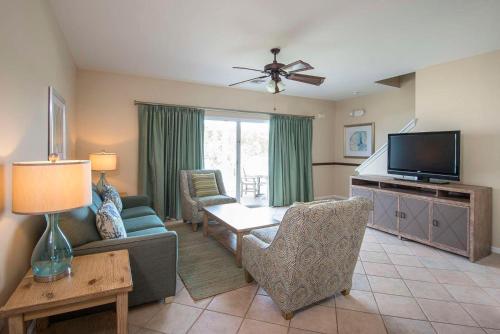 a living room with a couch and a tv at Hawks Cay Resort in Marathon