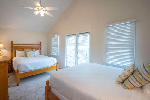 a bedroom with two beds and a ceiling fan at Hawks Cay Resort in Marathon