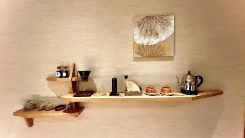 a shelf on a wall with various items on it at Hotel Miyama in Chichibu