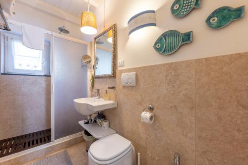 a bathroom with a toilet and a sink and a mirror at Villa Valentina in Levanto