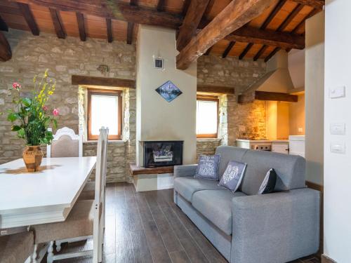 a living room with a couch and a table at Beautiful Apartment in Sestino with Garden in Sestino
