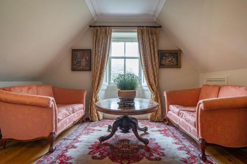 a living room with two couches and a table at Penninghame Estate - Tower Apartment in Challoch