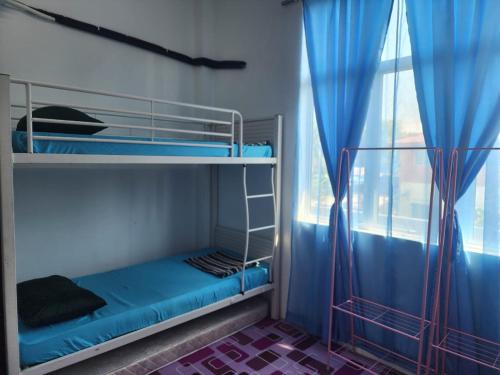 a bunk bed in a room with a window at Homestay Zaishazali in Gelugor