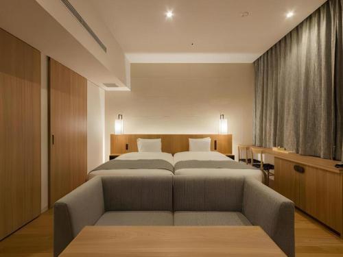a large bedroom with two beds and a couch at HOTEL CLAD in Fuji