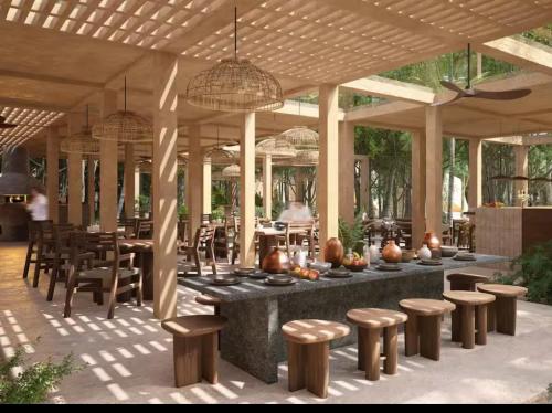 a patio with a table and some chairs and tables at New! Aflora Retreat Tulum, Loft With Pool And Gym in Tulum