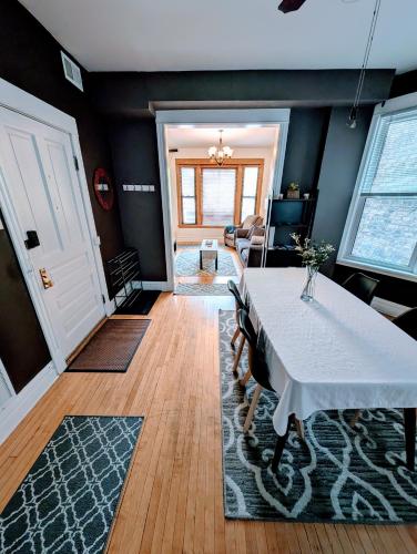 a dining room with a white table and chairs at The Roscoe Village Guesthouse in Chicago