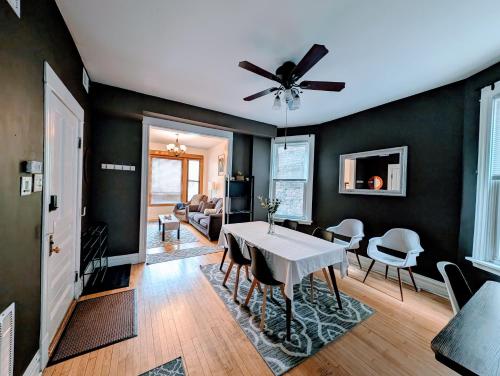 a dining room with a ceiling fan and a table at The Roscoe Village Guesthouse in Chicago