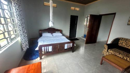 a bedroom with a wooden bed and a couch at The Mansion 