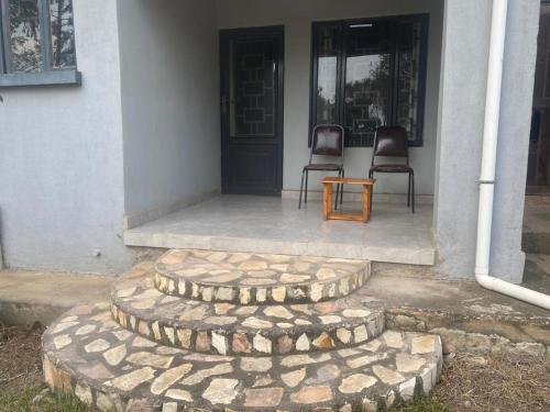 two chairs and a table in front of a house at The Mansion 
