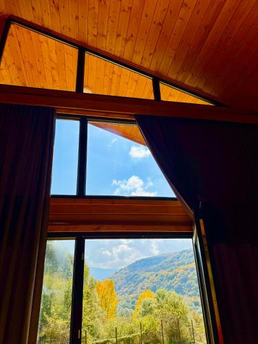 a window with a view of a mountain view at Sioni Hillside Cottages in Sioni