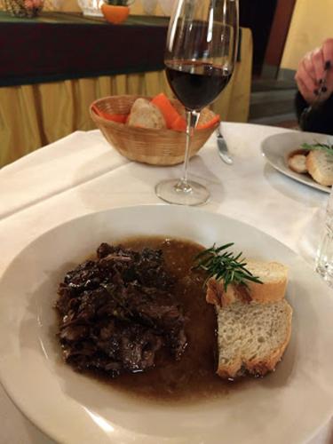 a plate of meat and bread with a glass of wine at Antica Casa Dei Rassicurati in Montecarlo
