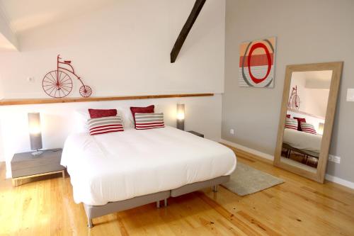 a bedroom with a large white bed and a mirror at Enjoy Lisbon Alfama 2 in Lisbon