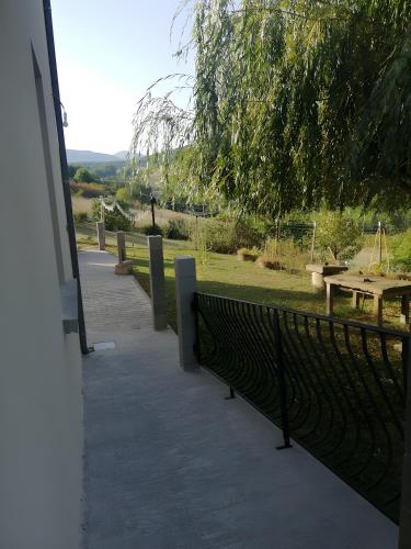 a walkway with a fence and a picnic table at Gîte À La Campagne in Bourdeaux