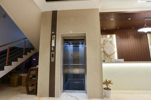 a hallway with a glass elevator in a building at Hotel Thirumala in Rāmeswaram