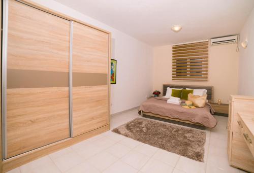a bedroom with a sliding glass door with a bed at The Rooftop of Apartments Lungo Mare in Ulcinj