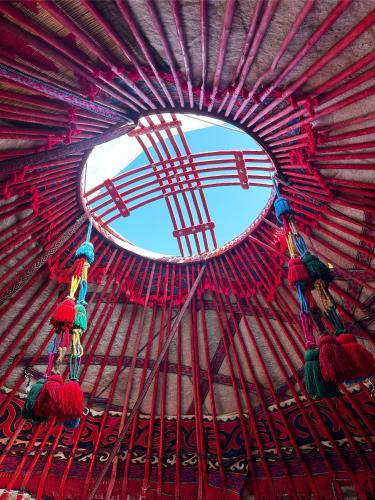 a round window in a building with a red ceiling at Karkyra in Dzhergalan