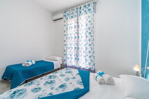 Postel nebo postele na pokoji v ubytování Le Quattro Perle Apartments