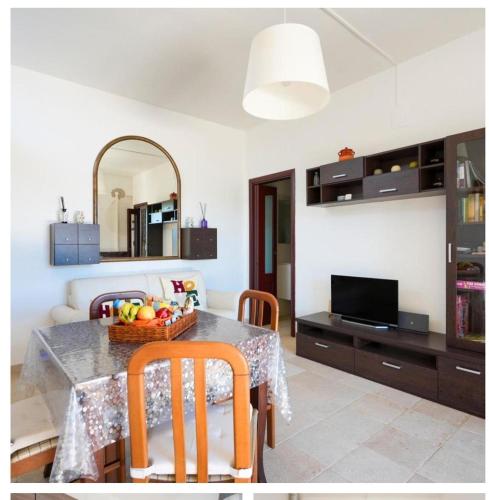 a living room with a table with a bowl of fruit on it at Casa vacanze La Campanella in Putignano