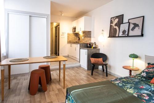 un salon avec une table et une cuisine dans l'établissement Le Cocon de Cordeliers, à Lyon