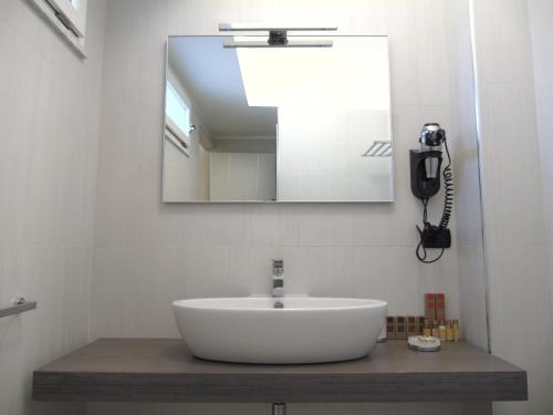 a bathroom with a sink and a mirror at Areté Luxury Room in Reggio Calabria
