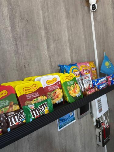a shelf with some food and snacks on it at Flats Hostel in Astana