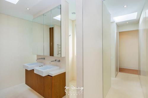 a bathroom with two sinks and a mirror at Jet Flamingo in Sydney