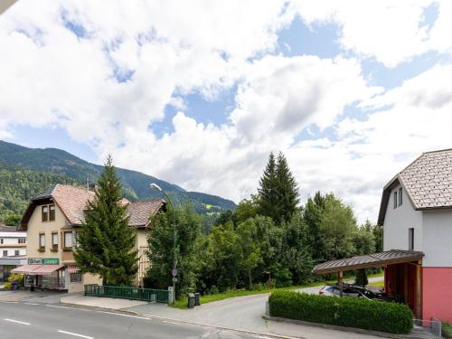 a street in a small town with houses and trees at Gailtaler apartment at an excursion location in Kötschach