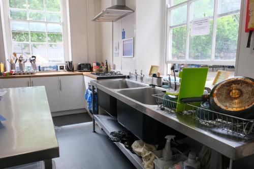 a kitchen with a sink and a counter top at The Full Moon Backpackers in Bristol