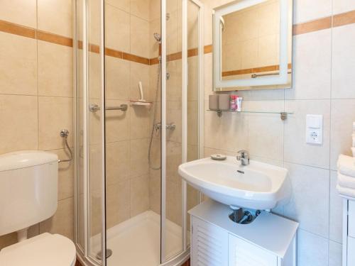 a bathroom with a shower and a sink and a toilet at Gailtaler apartment at an excursion location in Kötschach
