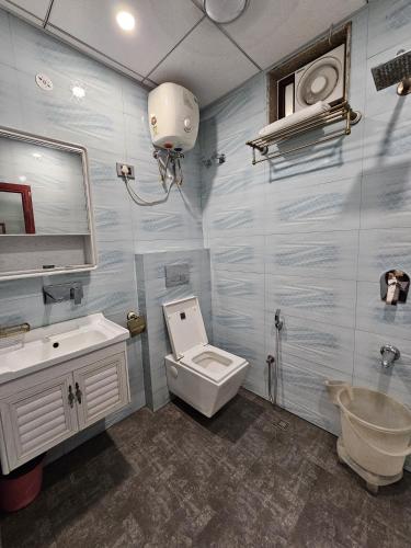 a bathroom with a toilet and a sink and a mirror at Hotel Polovictory Inn in Jāmb