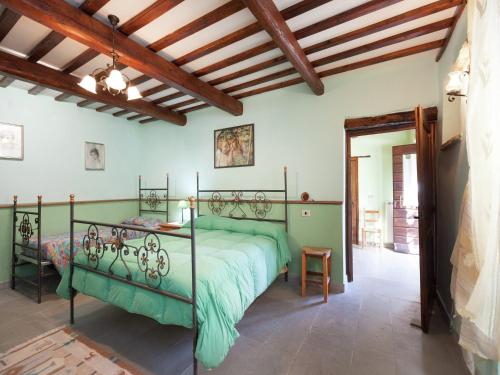 a bedroom with a green bed in a room at Farmhouse in Apecchio with Swimming Pool, Terrace, Garden in Apecchio