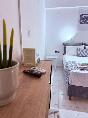 a bedroom with a bed and a table with a plant at Argiro's apartment at Agia Galini in Agia Galini