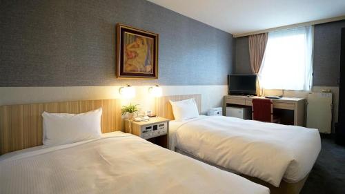 Hotel Riverge Akebonoにあるベッド